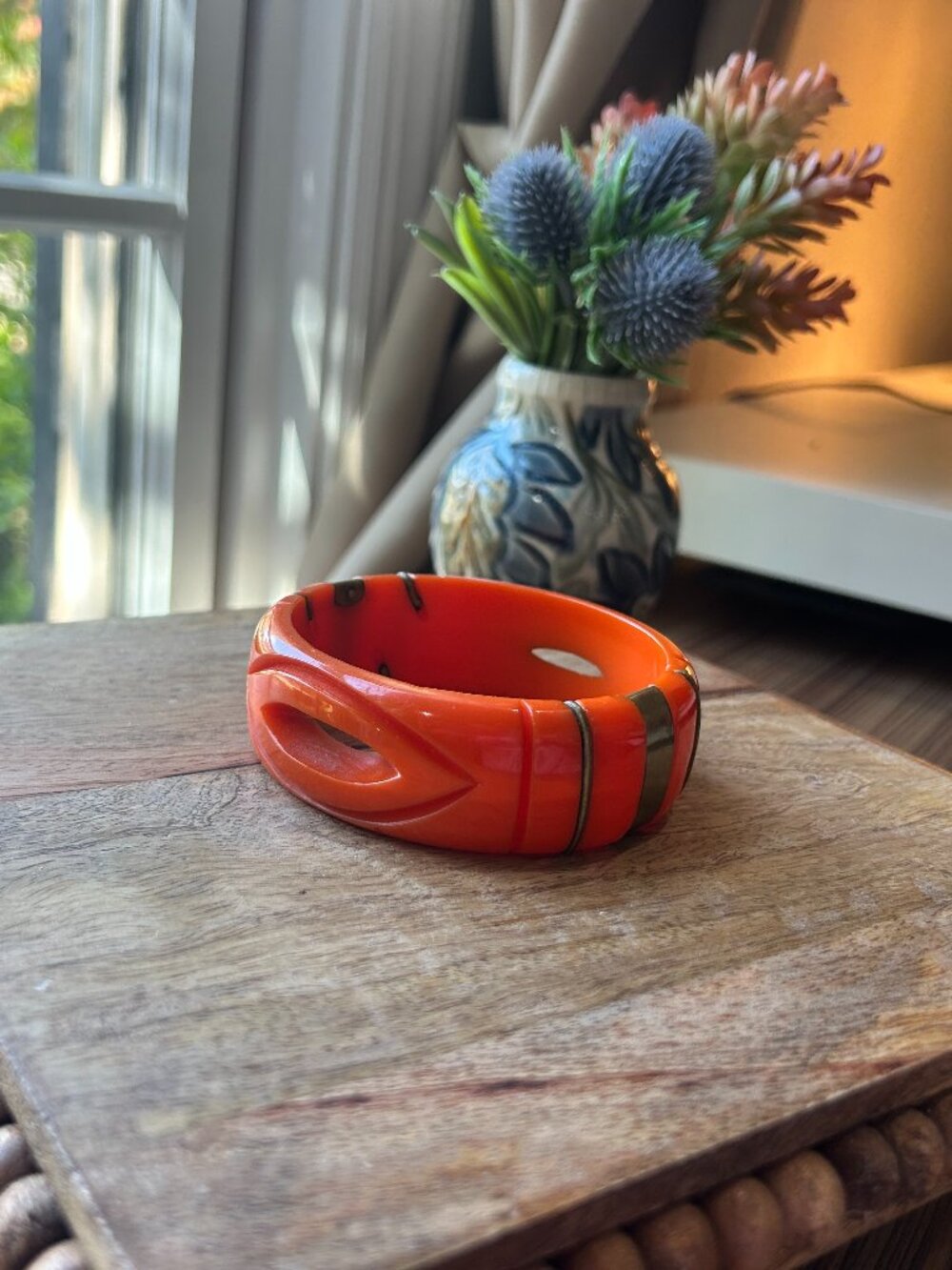 Vintage orange carved bakelite with brass colored bands